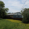 View from the road, the lot on the left is empty.  There is a nice house on the corner.